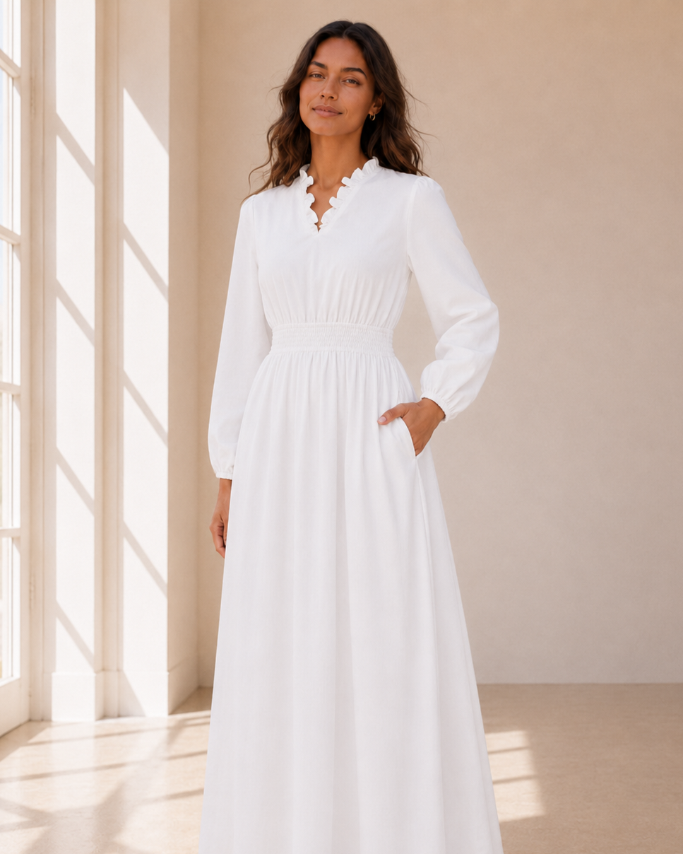 The Brigham City soft white LDS temple dress with a ruffle collar, tiered skirt, and pockets