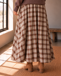 The Maplewood brown plaid cotton midi skirt with flared silhouette styled with a brown sweater and ankle boots