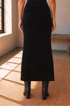 Back view of The Haven Black Ribbed Knit Midi Skirt showing the ribbed knit texture and fitted silhouette