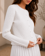 Close-up of ivory textured knit button cardigan showing raised knit pattern and buttons