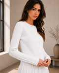 Model wearing ivory textured knit button cardigan with white skirt, front view
