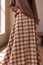 Close up of The Maplewood brown plaid midi skirt showing the cotton spandex fabric and flowing flared shape